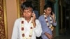Former Radio Free Asia journalists Uon Chhin and Yeang Sothearin are seen talking on their cell phone after being released on bail in Phnom Penh, Cambodia, August 21, 2018. (Aun Chhengpor/VOA Khmer) 