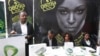 FILE - Staff of Internet and smartphone service provider Etisalat Nigeria wait for customers at a promotional stand in Lagos, Nigeria.