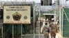 FILE - U.S. military guards enter the Camp Delta military-run prison at the Guantanamo Bay U.S. Naval Base, Cuba. 