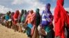 Women who fled drought queue to receive food distributed by local volunteers at a camp for displaced persons in the Daynile neighborhood on the outskirts of Mogadishu, in Somalia, May 18, 2019. 