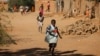 FILE - Children run home from school after hearing gunfire and explosions in Gao, Feb. 21, 2013. The United Nations Children’s Fund reports insecurity in northern Mali is keeping more than 380,000 children out of school.