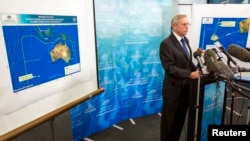 John Young, general manager of the emergency response division of the Australian Maritime Safety Authority (AMSA), answers a question as he stands in front of a diagram showing the search area for Malaysia Airlines Flight MH370 in the southern Indian Ocea