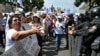 A woman confronts police officers as employees of the Judiciary, who are on an indefinite strike, protest in front of the Supreme Court of Justice in Mexico City on August 25, 2024.