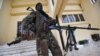 A Seleka coalition rebel stands guard on March 25, 2013 inside the presidential palace compound in Bangui. 