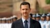 FILE - Syrian President Bashar al-Assad inspects a guard of honor at the Presidential Palace in New Delhi, India, June 18, 2008. 