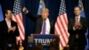 Republican presidential candidate Donald Trump, is flanked by his two sons, Donald Trump Jr., left, and Eric, while speaking at a caucus night rally Tuesday, Feb. 23, 2016.
