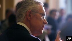 Senate Majority Leader Harry Reid of Nevada speaks to reporters as lawmakers moved toward resolving their feud over filibusters of White House appointees on Capitol Hill in Washington, Jul. 16, 2013. 