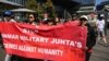 FILE - People hold a banner during a public rally held for the Myanmar community in Australia calling for ASEAN to not support the Myanmar military junta, outside the ASEAN-Australia Special Summit venue, in Melbourne, Australia, March 4, 2024.