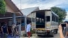 In this photo released by the San Sai District Administrative Office, journalists working for Democratic Voice of Burma, prepare to get into a van after being arrested at San Sai District in Chiang Mai province north of Thailand Sunday, May 9, 2021…